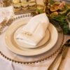 gold allure cutlery, gold rimmed glassware and gold beaded glass charger plate