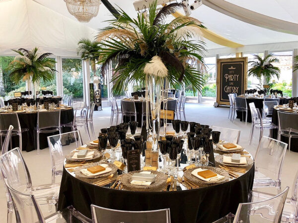black linen tablecloths on round dining event banquet tables at a themed great gatsby charity event
