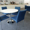 round oro bistro table with blue rio chairs in a luxury hospitality area
