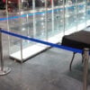 blue and chrome retracting belt barriers at ExCel London