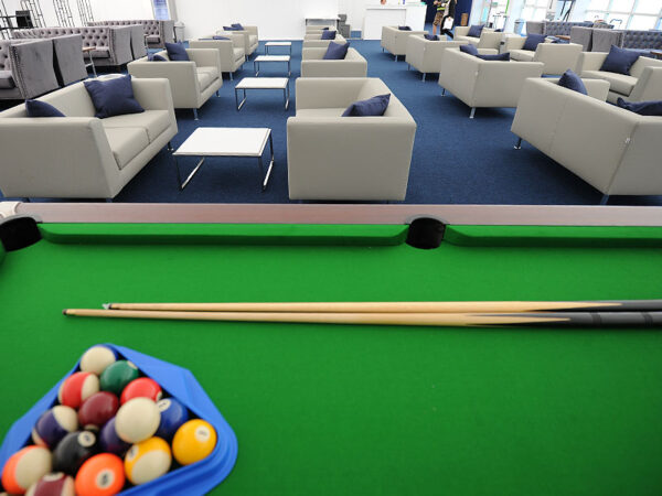 a bank of grey infiniti sofas with square genoa coffee tables behind a pool table