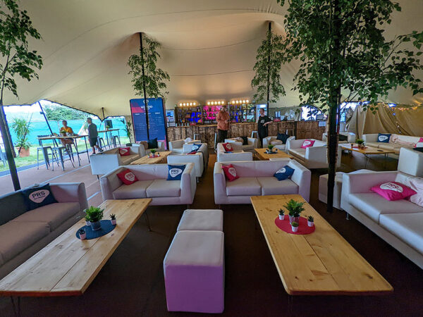 sofas and wooden coffee tables in a marquee