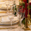 gold rimmed glassware with gold beaded glass charger plates and gold allure cutlery