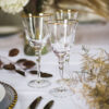 gold rimmed glassware with gold beaded glass charger plates and gold allure cutlery