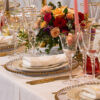 gold rimmed glassware with gold beaded glass charger plates and gold allure cutlery