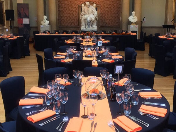 round banquet tables covered with black tablecloth at a vip dining event