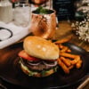 black mattone plate with burger and fries