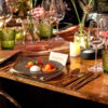 enamor copper cutlery on vintage trestle table and invitation glassware