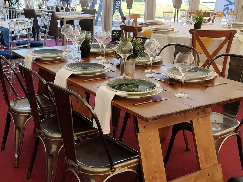 What should I consider when hiring rustic or trestle tables for an event?