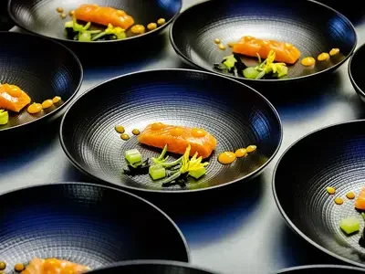 Black dinner bowls being used by a professional caterer at an event